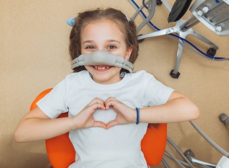 A little girl getting nitrous oxide sedation at the dentist.