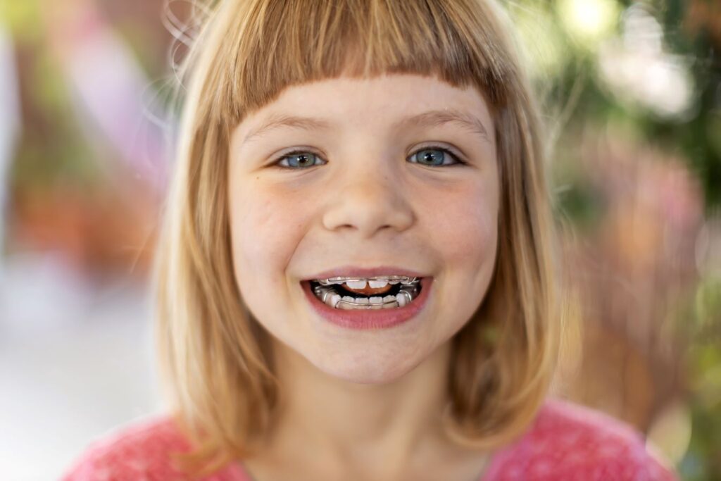 A young girl with braces.